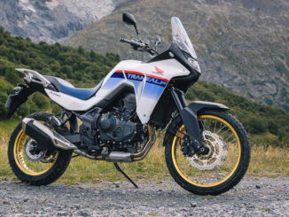 Eine weiße Honda XL 750 Transalp steht 2023 auf einer Schotterpiste in den Alpen.