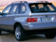 BMW X5 Modelljahr 2001 (10/2010) in silber steht auf einem Feldweg.