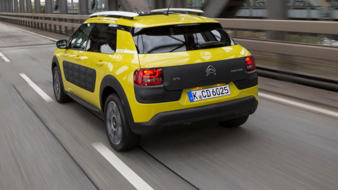 Ein gelber Citroen C4 Cactus fährt über ein Brücke.