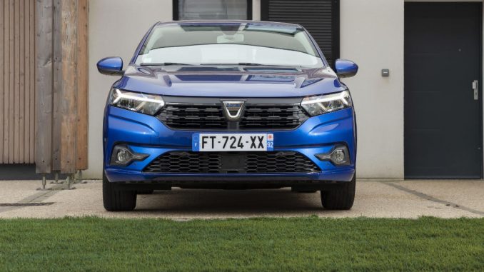 Ein blauer Dacia Sandero, Fünftürer, steht 2020 vor einem Reihenhaus.