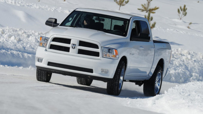 Ein weißer Dodge RAM 1500 fährt im Winter 2011 über eine verschneite Straße.