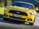 Ein gelber Ford Mustang fährt 2015 durch die Voralpenlandschaft.Mehr als 10.000 Ford Mustang haben Kunden europaweit seit Ende 2014 bestellt. Im Dezember des vergangenen Jahres waren die Auftragsbücher für den Sportwagen geöffnet worden.