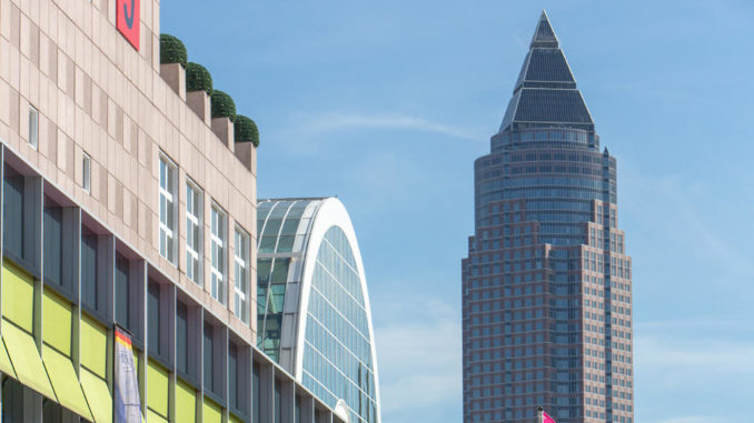 Messegelände Frankfurt mit Halle 9 im Vordergrund und Messeturm im Hintergrund.