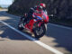 Eine rote Honda CBR650R ist 2024 auf einer Landsatraße unterwegs.