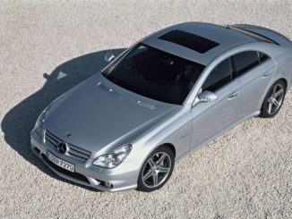 Ein silberner Mercedes-Benz CLS 63 AMG (C219), steht 2006 auf einer Kiesfläche.