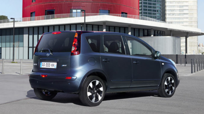 Ein blauer Nissan Note der ersten Generation steht auf einem Parkplatz.