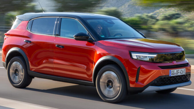 Ein roter Opel Frontera fährt 2025 über eine Landstraße.